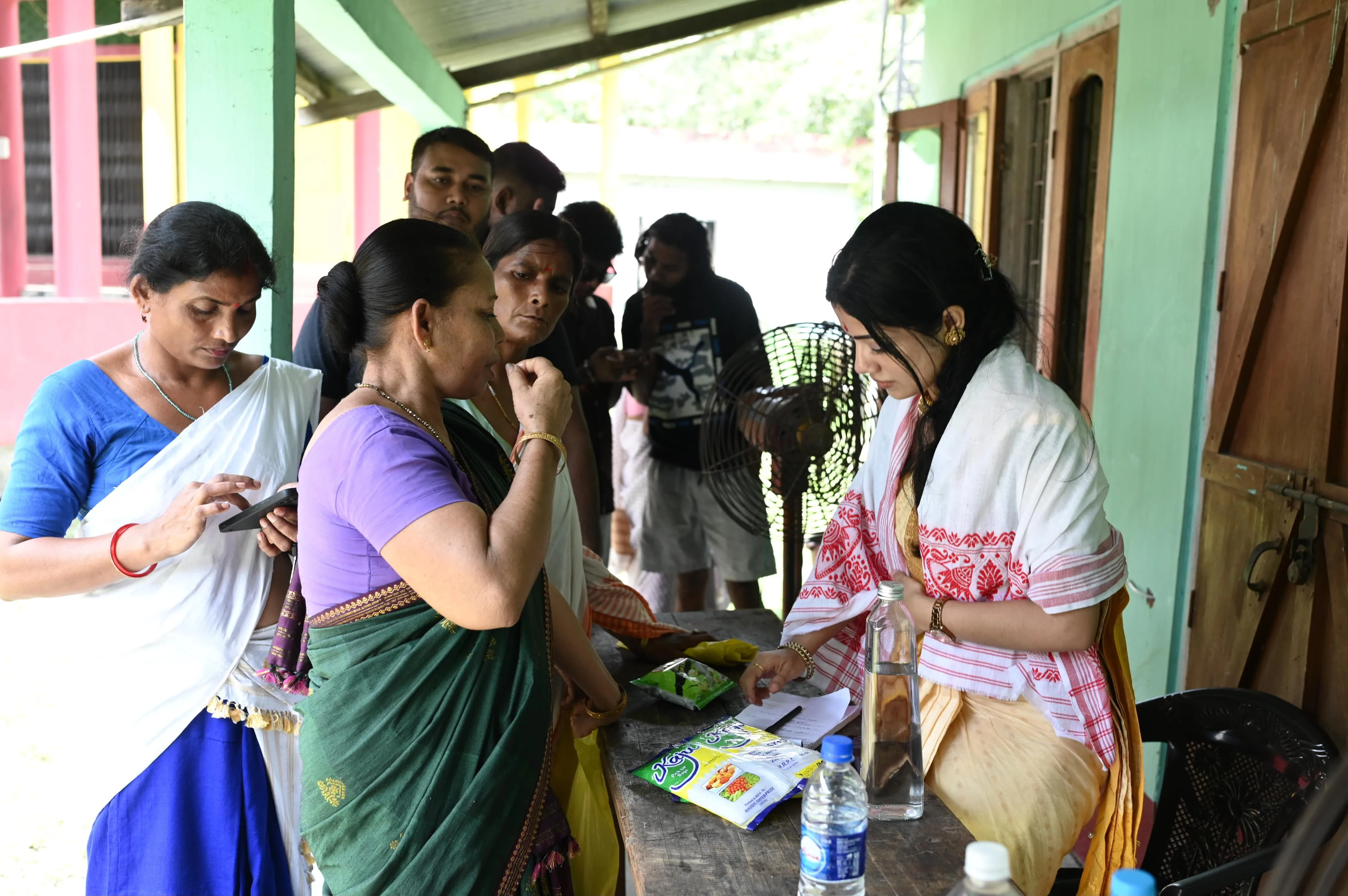 Doctor examining elderly patient at community health camp